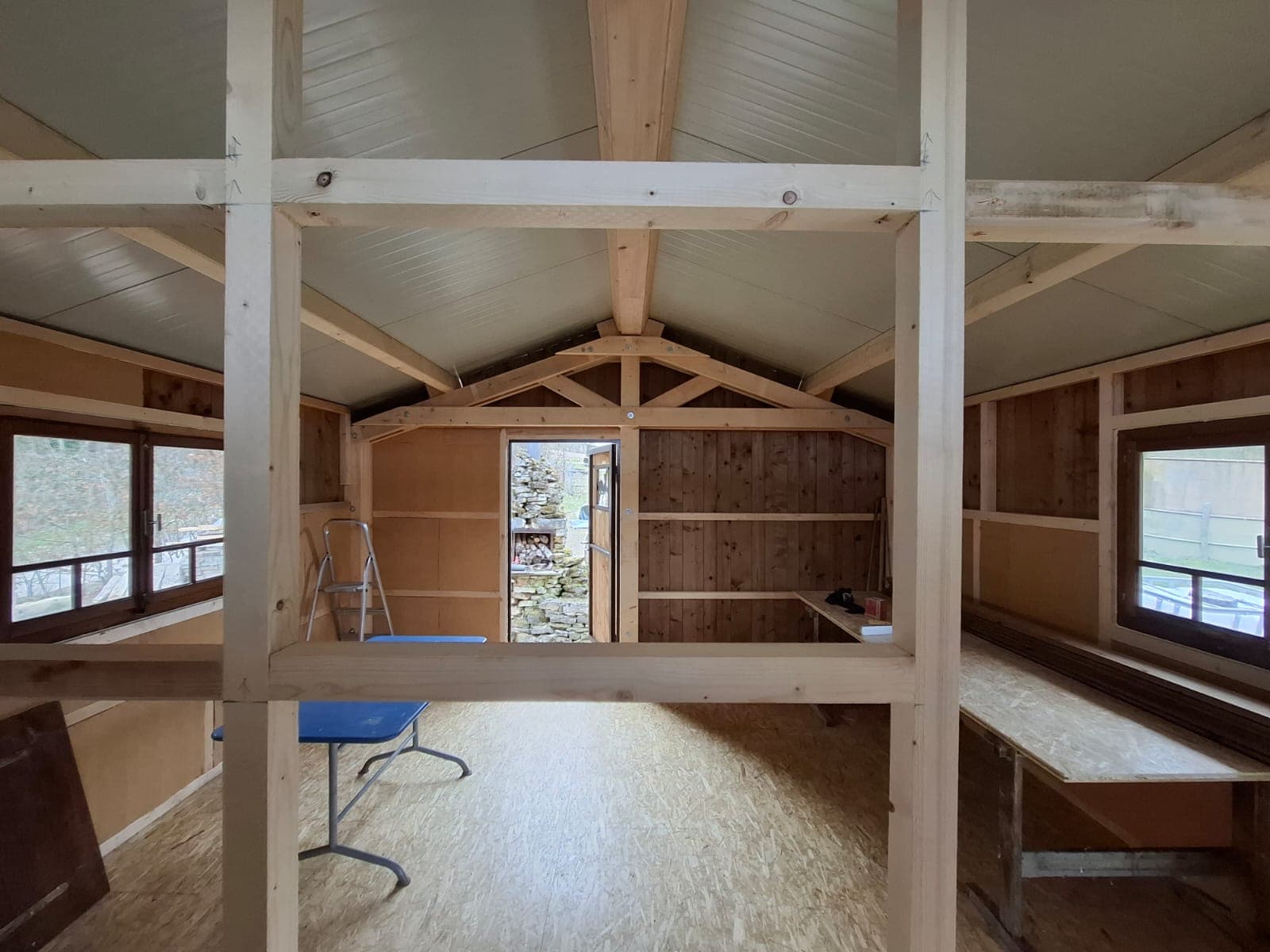 Interior view of timber framing with visible roof structure and natural light