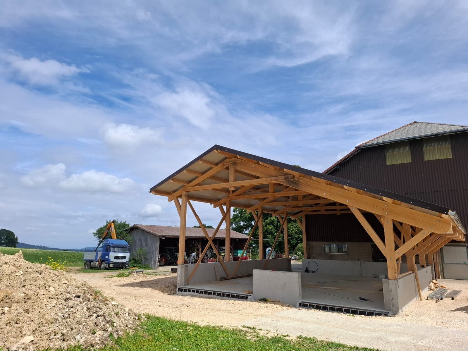 Canopy timber frame structure under construction, blue sky