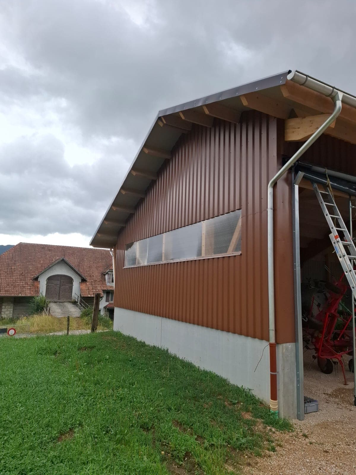 Agricultural hall facade detail with exposed timber eaves